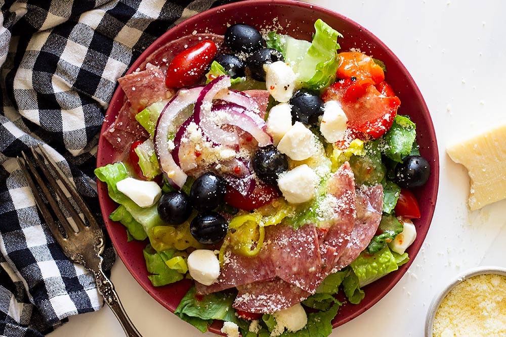 Green Salad Recipes - Antipasto salad topped with parmesan cheese.