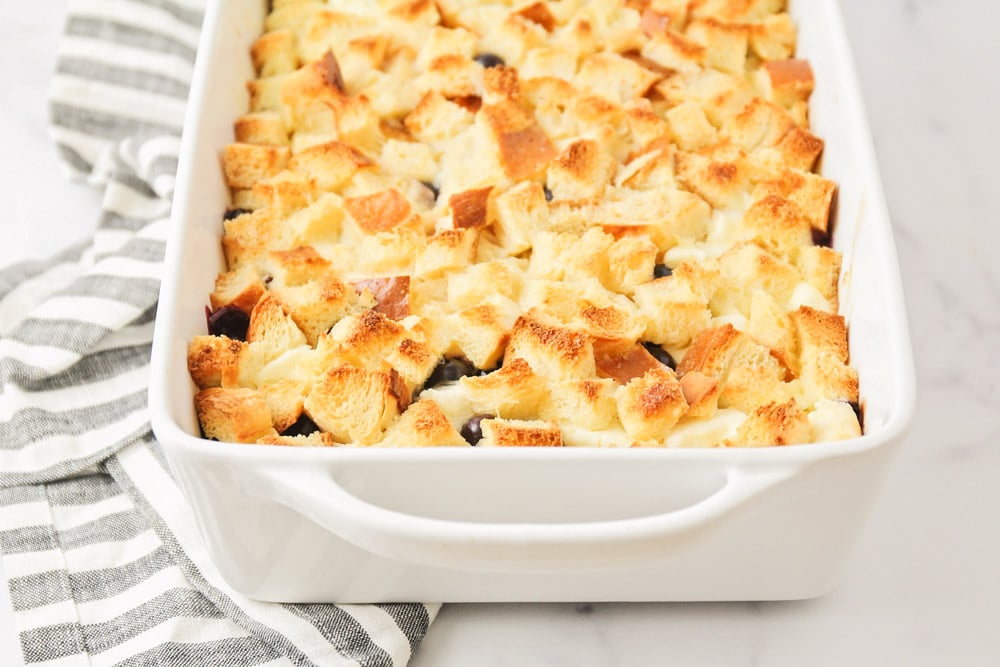 Blueberry french toast casserole in a white baking dish.