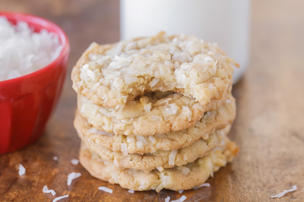 Easy cookie recipes - coconut cookies stacked on a wooden table.