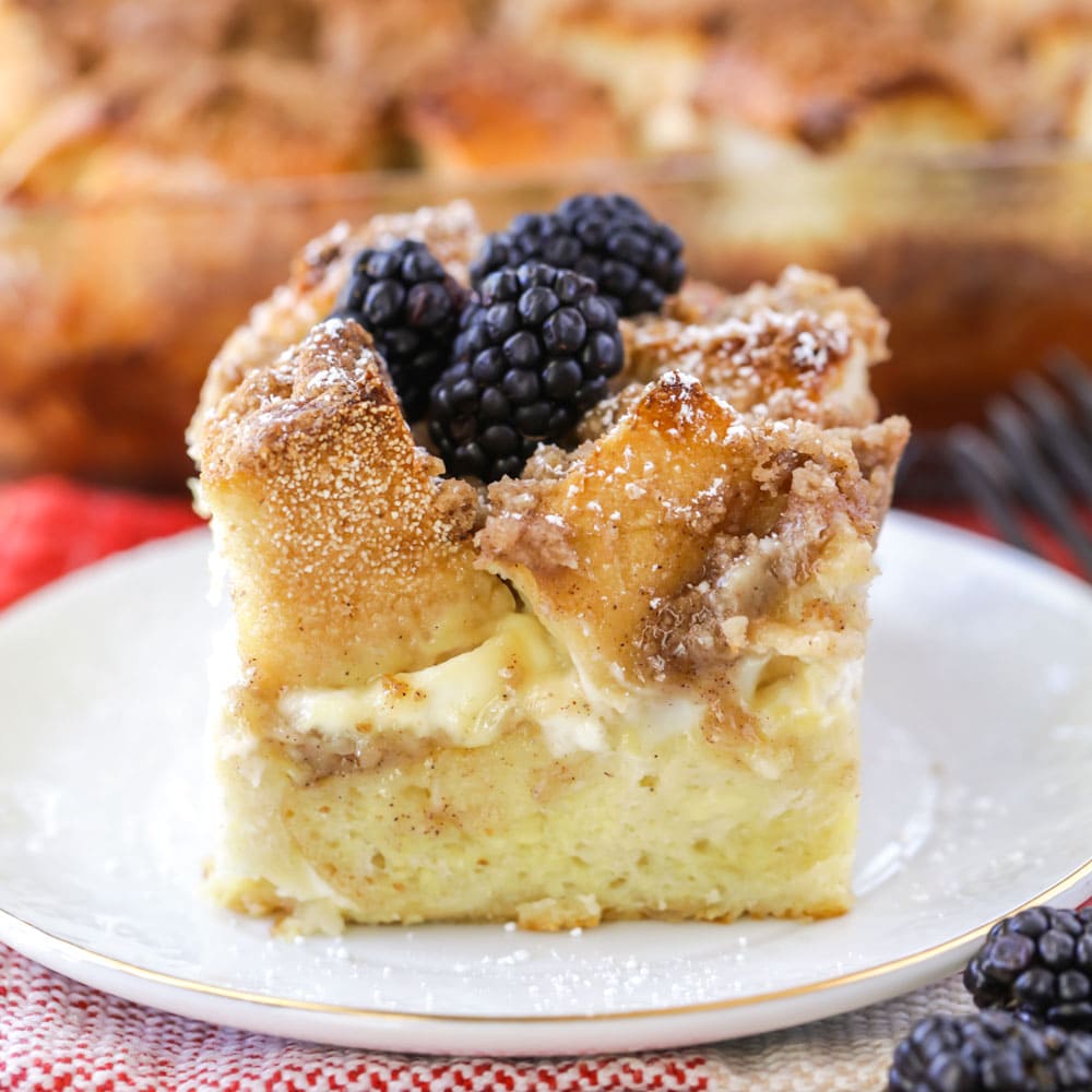 A slice of french toast casserole with cream cheese on a plate.