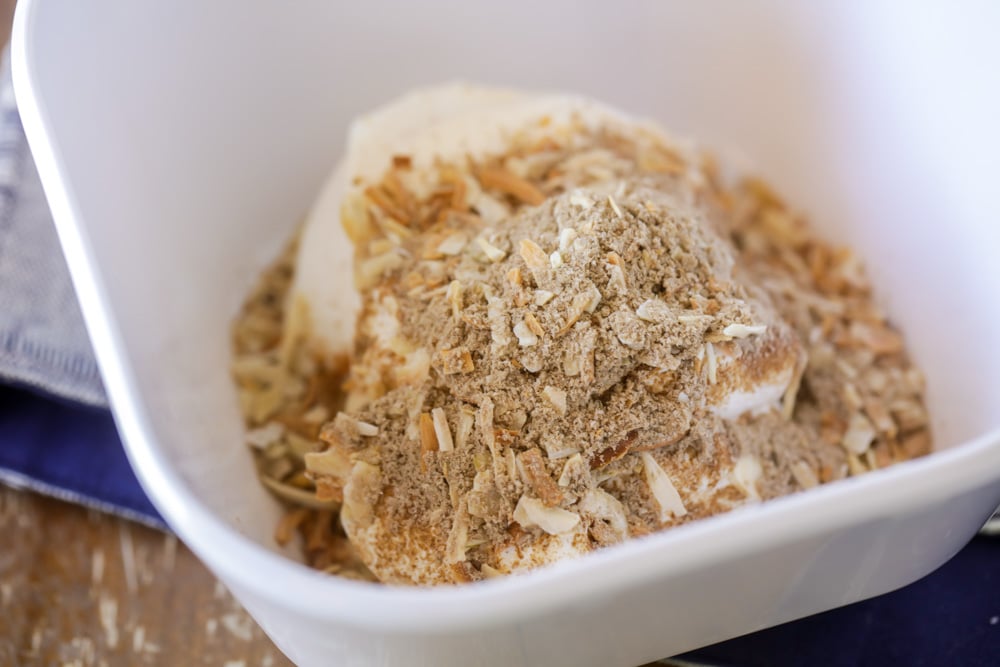 Making french onion dip in a white bowl 