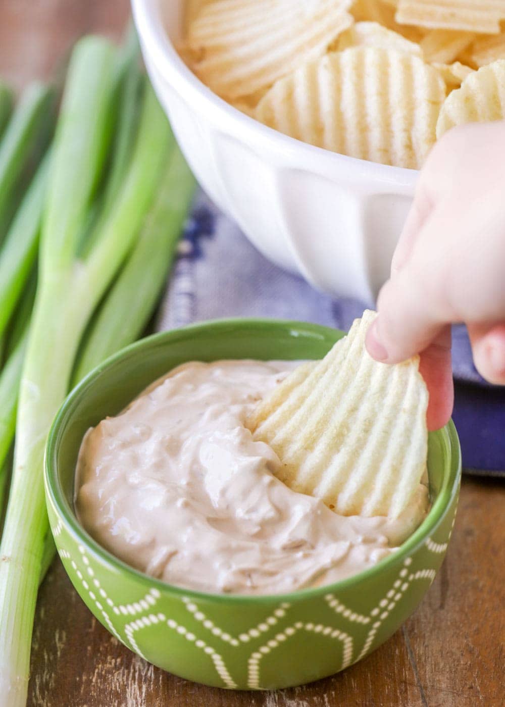 Dipping a chip into homemade french onion dip