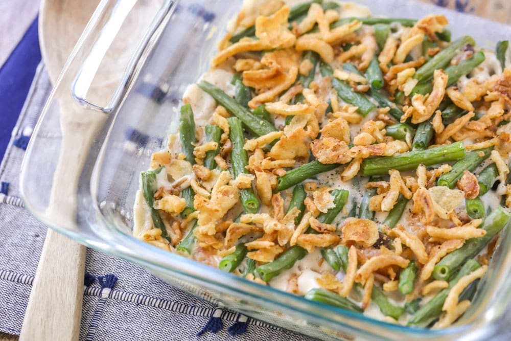 Fresh green bean casserole served in a glass dish.