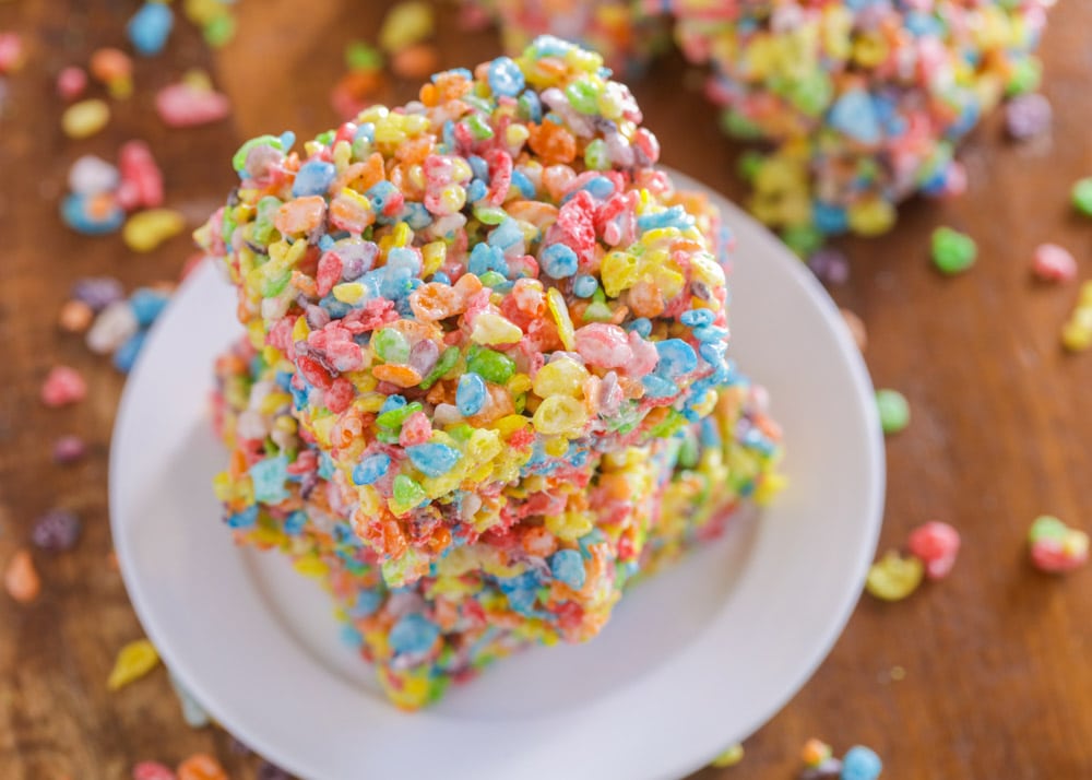 A stack of fruity pebbles treats on a white plate