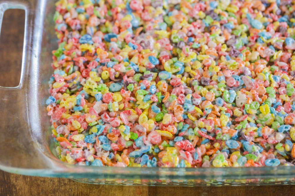 Fruity pebble rice crispy treats pressed in a glass pan