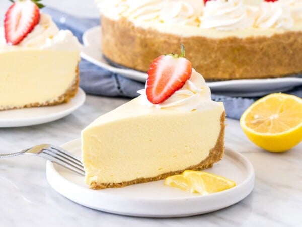 Slice of jello cheesecake with whipped cream and a strawberry on top