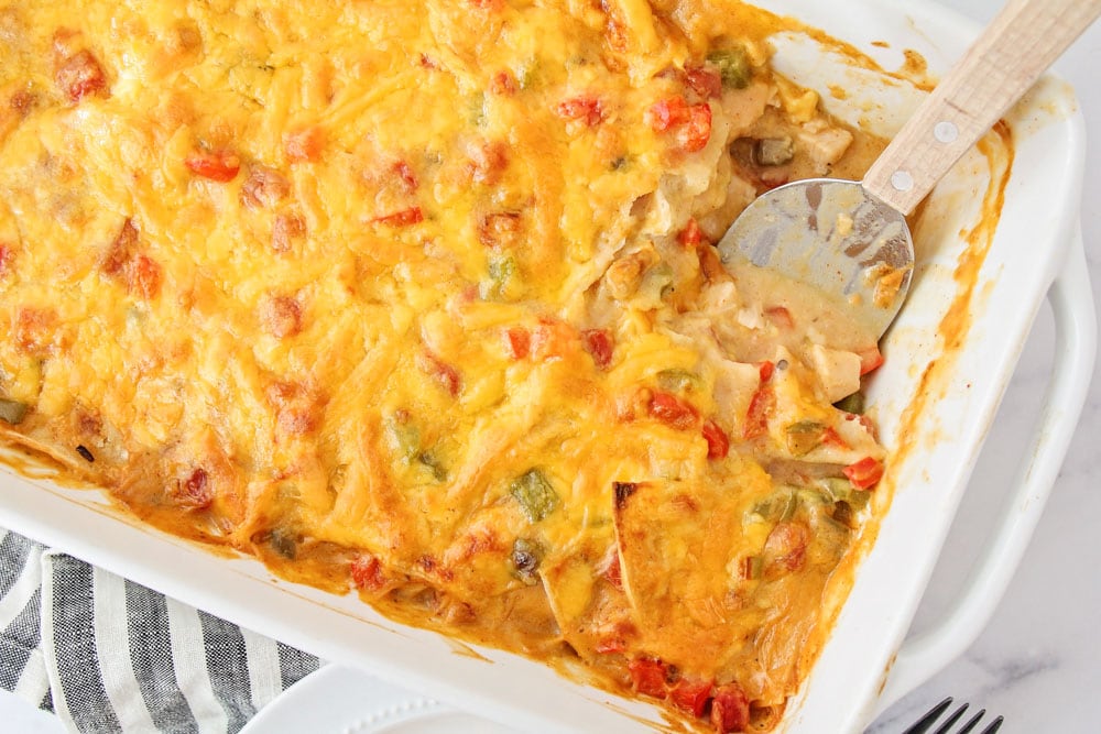 King Ranch Chicken Casserole recipe in baking dish with a scoop missing.