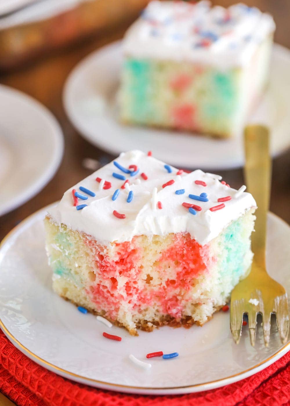 4th of July Poke cake recipe on a white plate.
