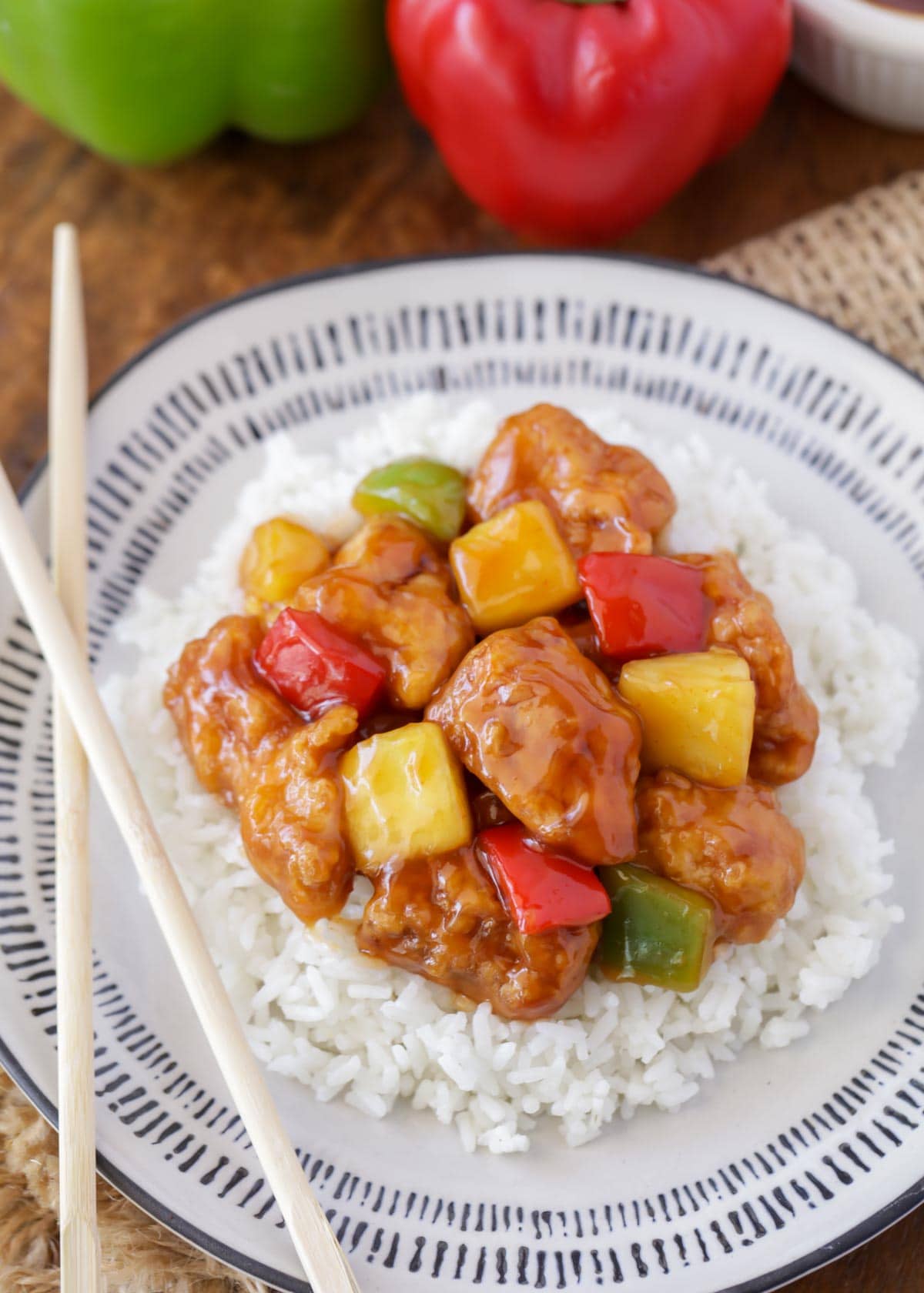 Sweet and sour chicken with white rice on a white and grey plate