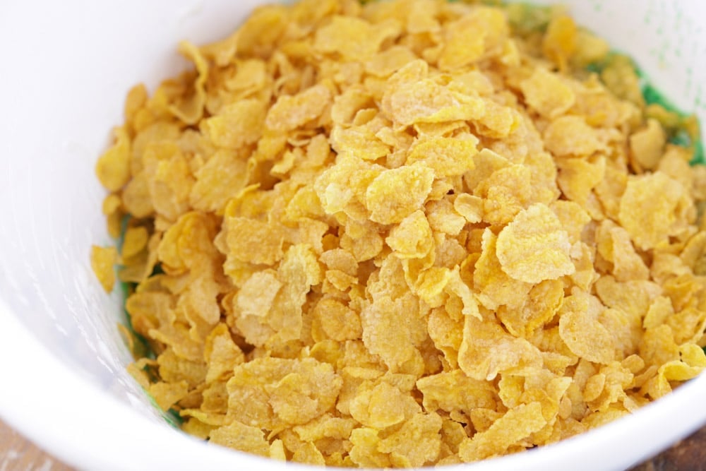 Cornflakes in a mixing bowl used to make cornflake wreath cookies.