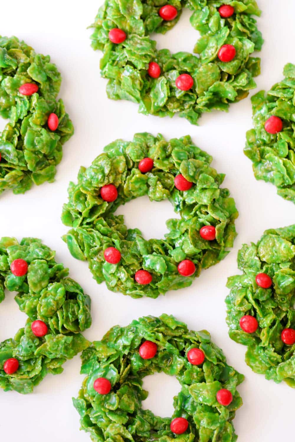 Cornflake Christmas wreath cookies topped with red hot candies.
