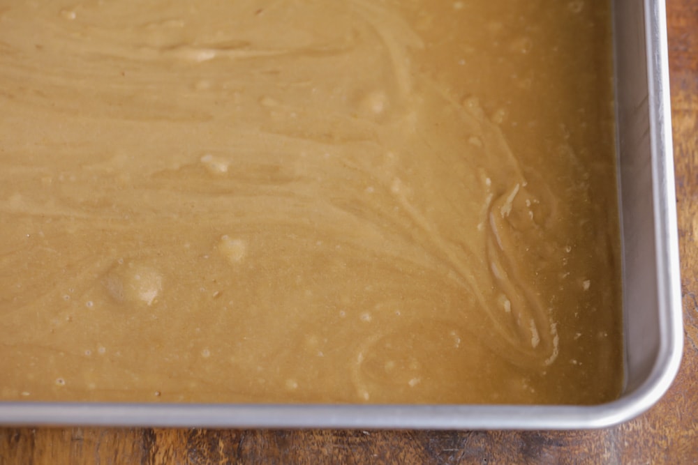 Cookie bar dough in a metal baking pan