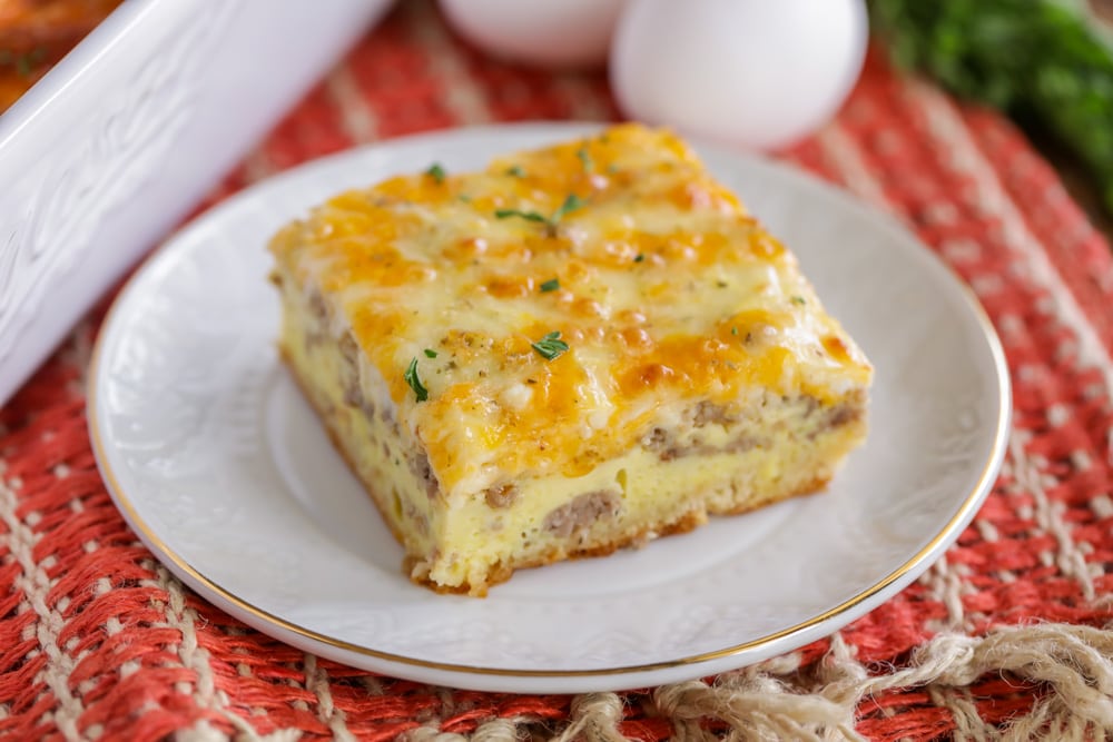 A slice of crescent roll breakfast casserole on a white plate