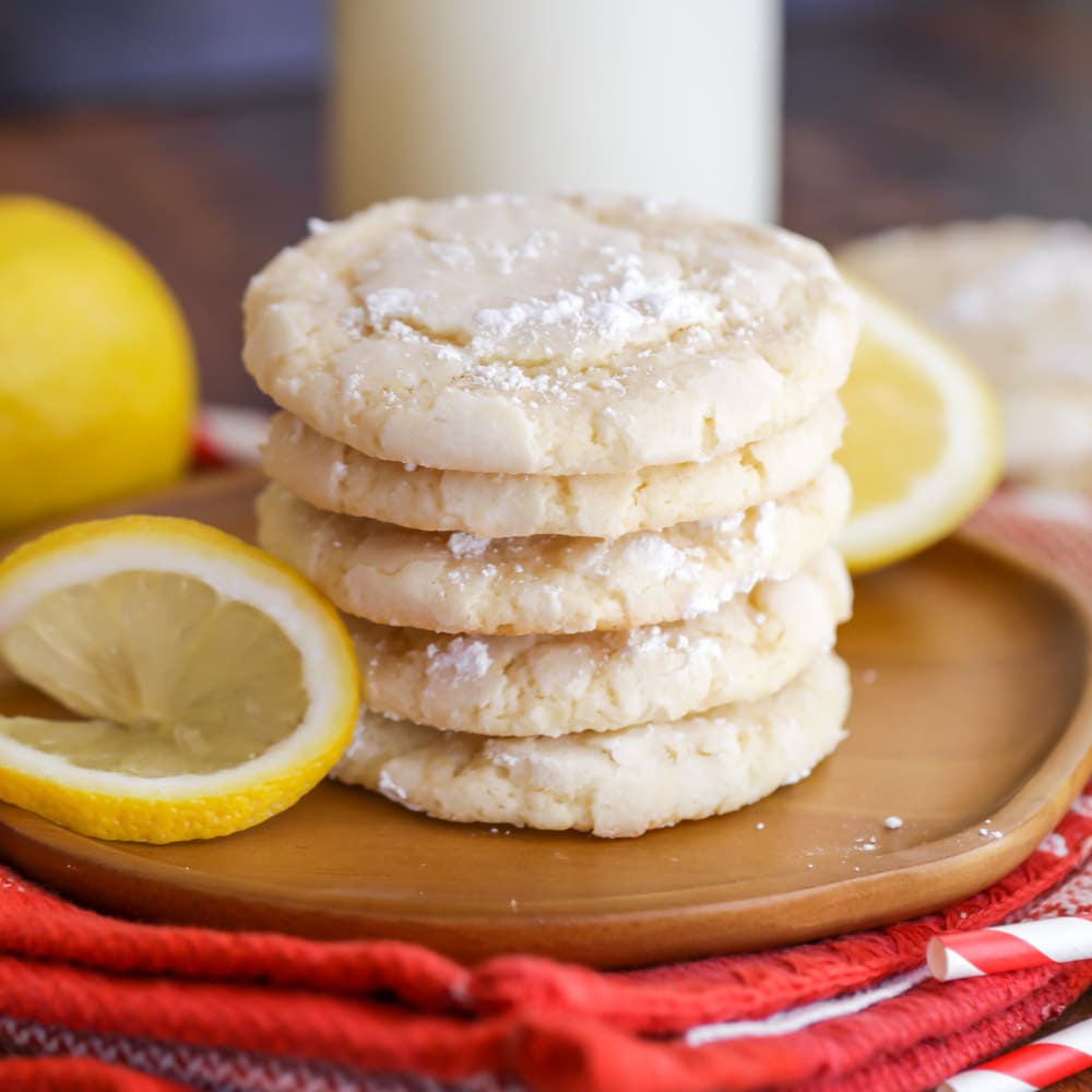 Lemon Crinkle Cookies stacked on plate.