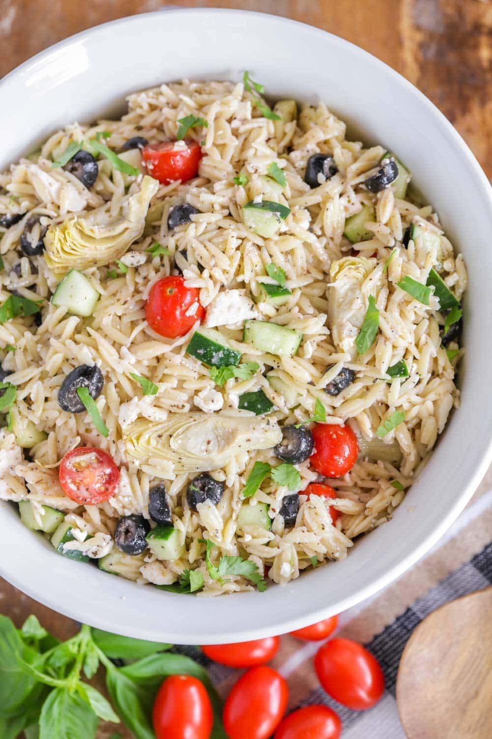 Greek Orzo pasta salad in a white serving bowl