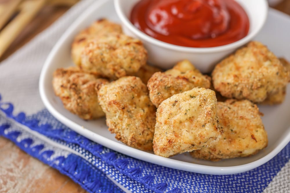 Chicken Dinner Ideas - Baked chicken nuggets piled and served with ketchup.