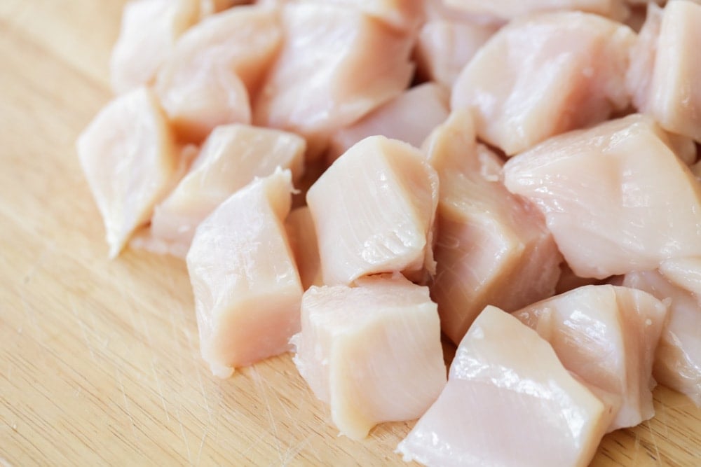 Close up of cut up chunks of chicken.