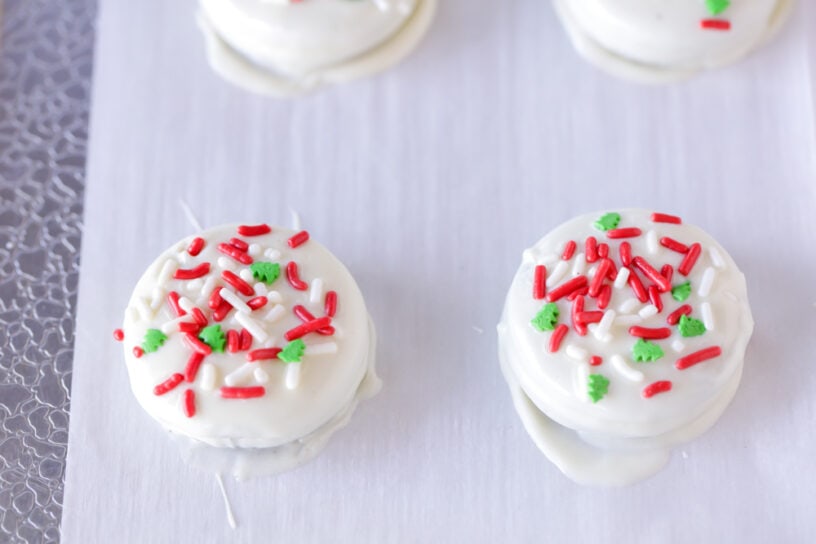 White chocolate covered Oreos with sprinkles.