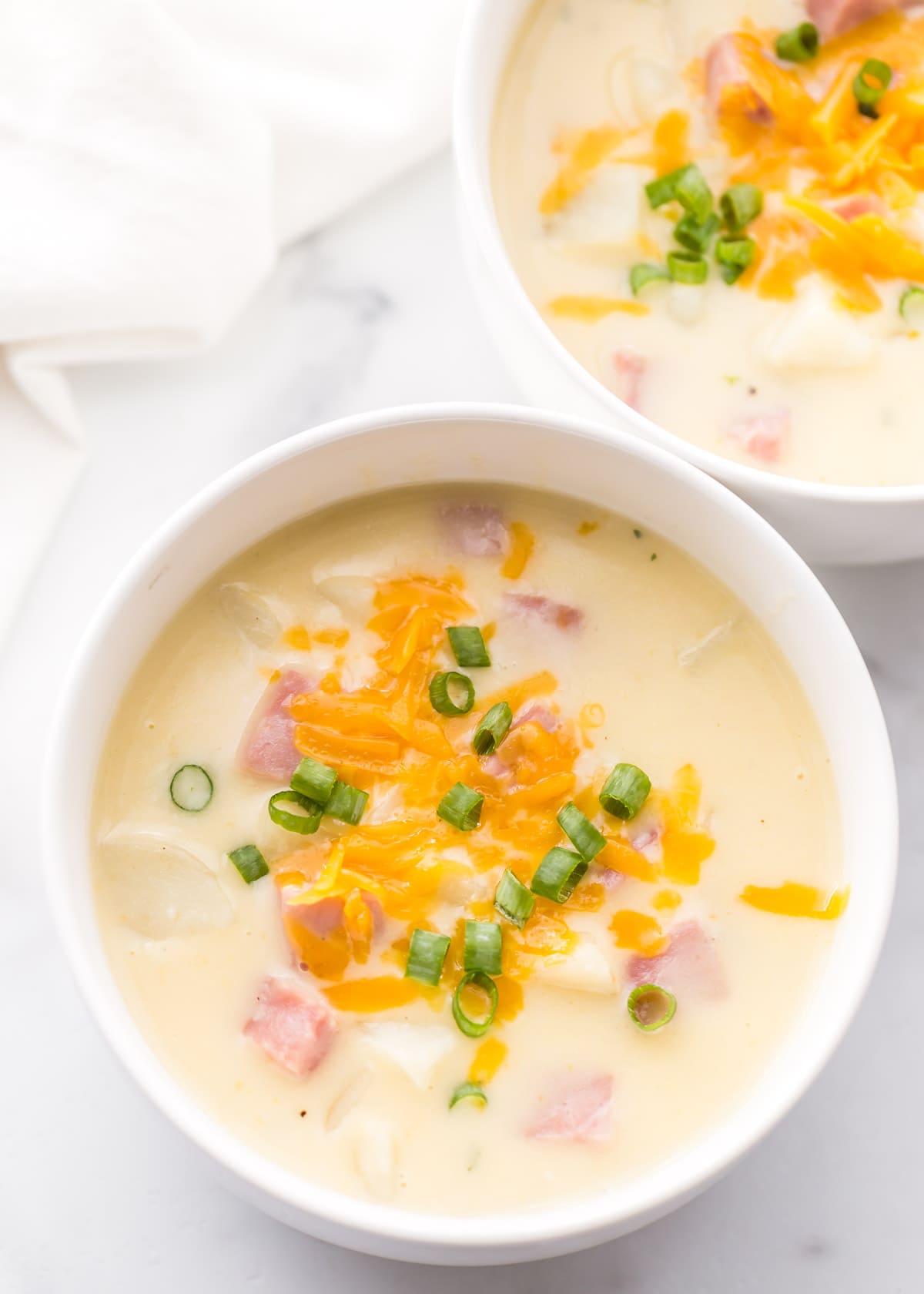 Ham and potato soup recipe in white bowl