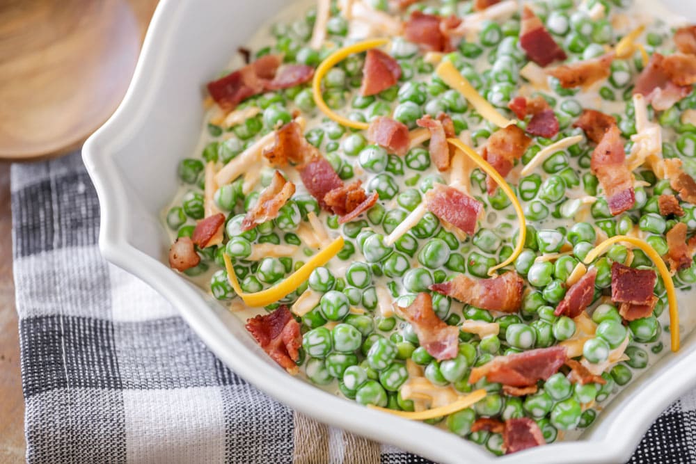 Pea salad with bacon and cheese in a serving dish