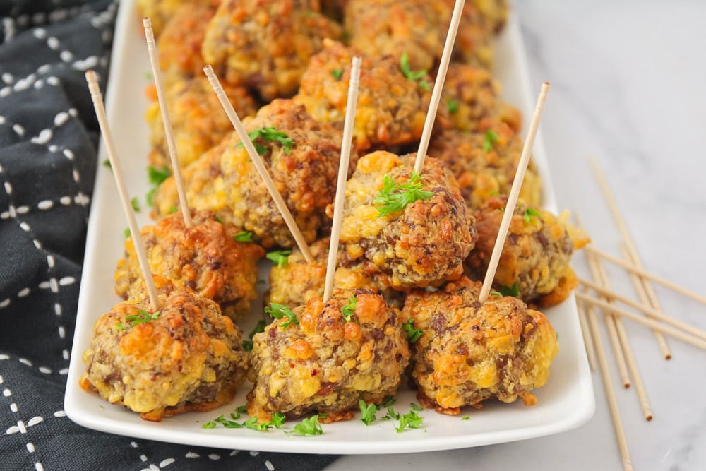 Sausage balls on toothpicks, served on a platter