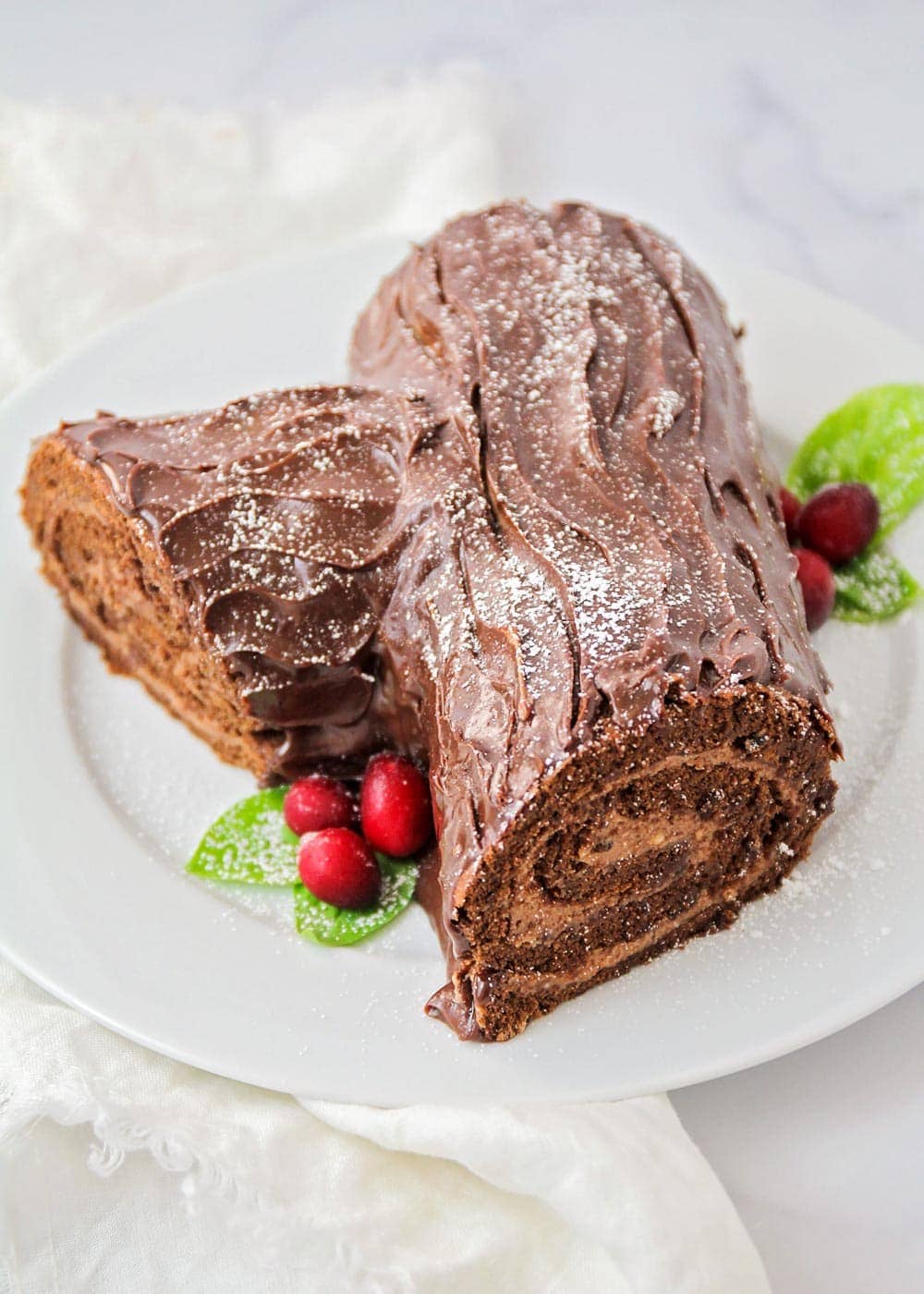 A decorated yule log on a white plate