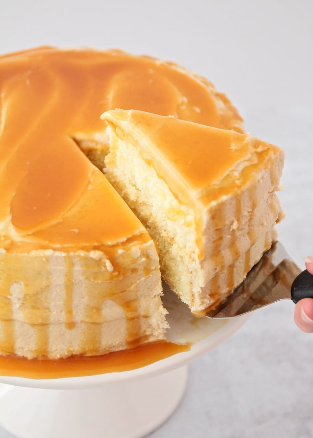 Cakes that feed a crowd - caramel frosted cake being sliced.