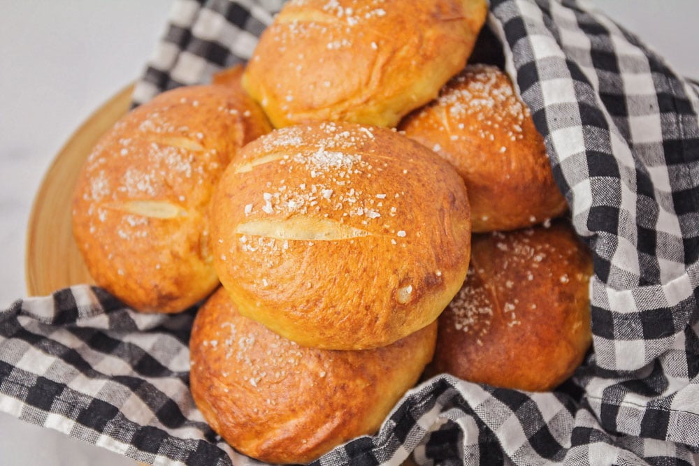 Dinner Rolls and Biscuits - Pretzel rolls in a black and white gingham towel.