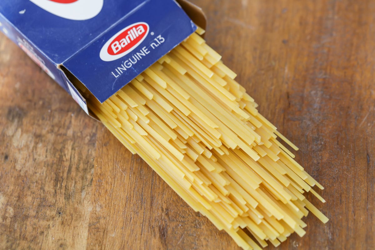 Uncooked linguine coming out of pasta box