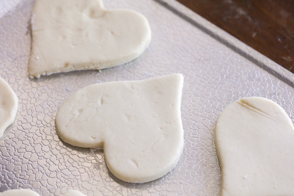 Heart shaped sugar cookies on a baking pan