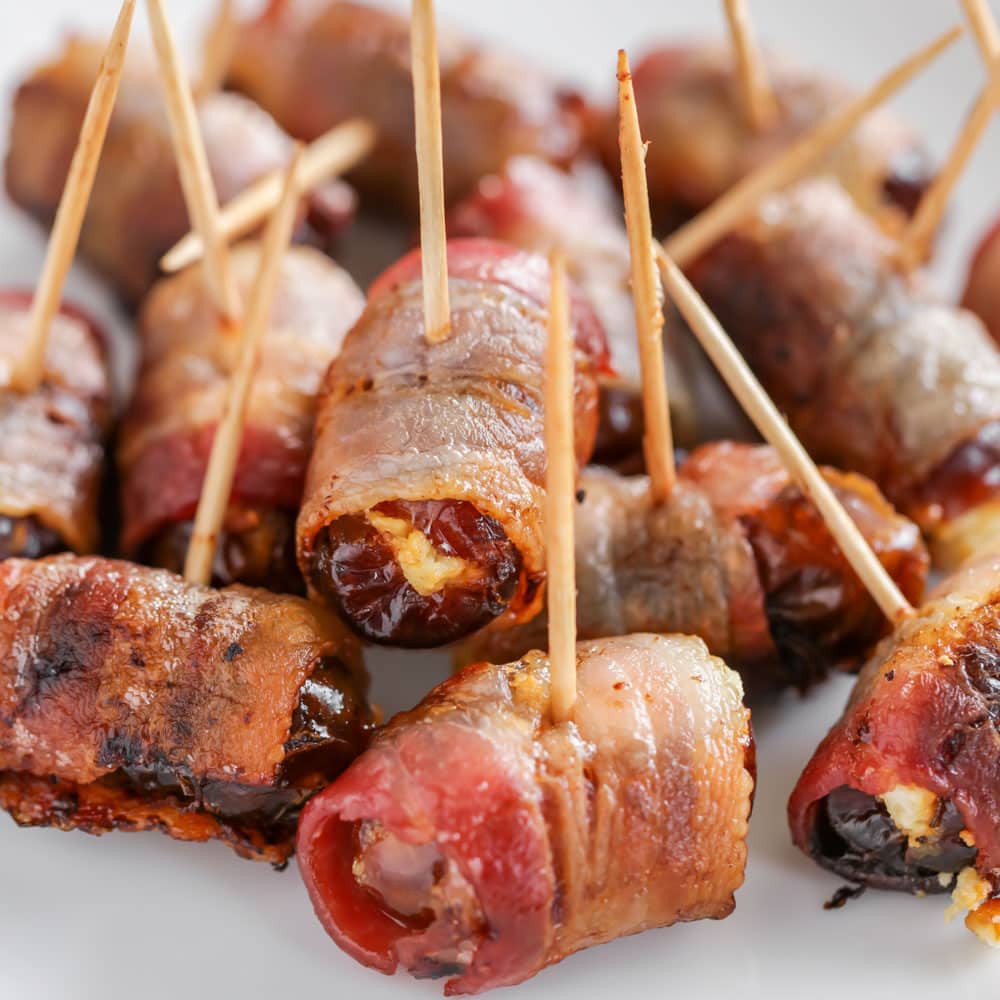 Finger food appetizers - bacon wrapped dates stuck with toothpicks.