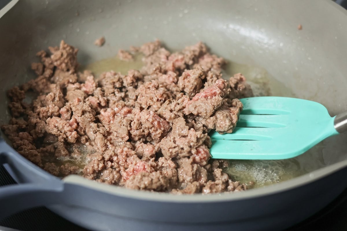 Cooking ground beef in skillet.