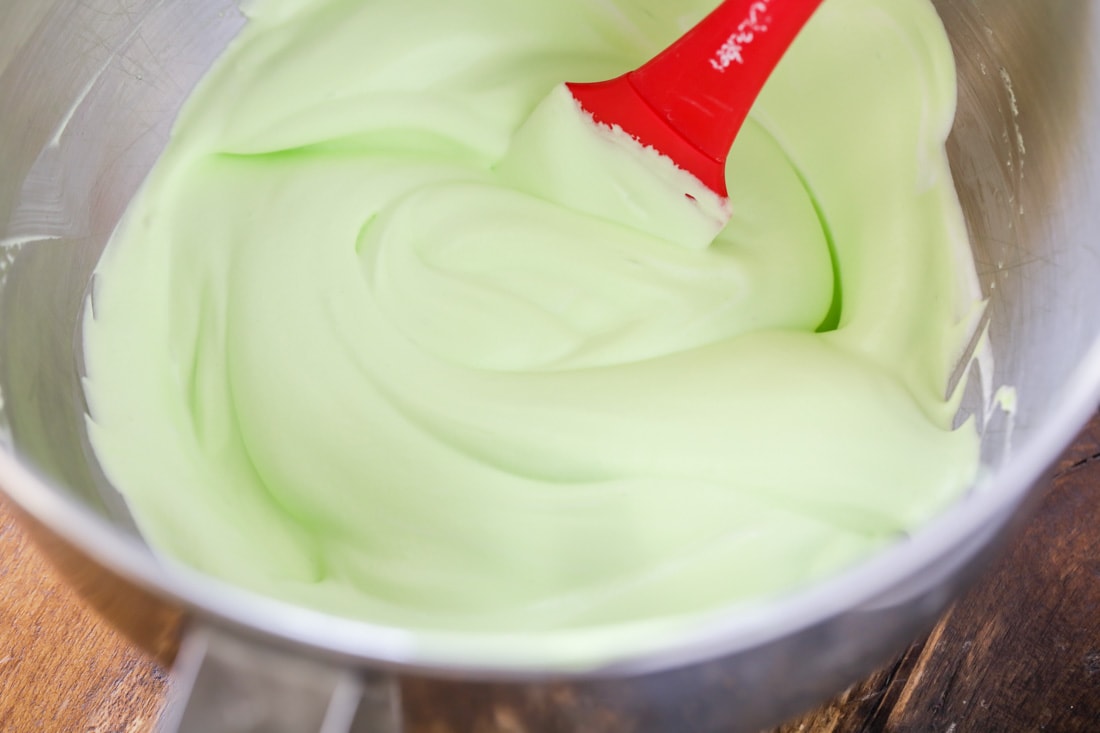 Green whipped cream in mixing bowl