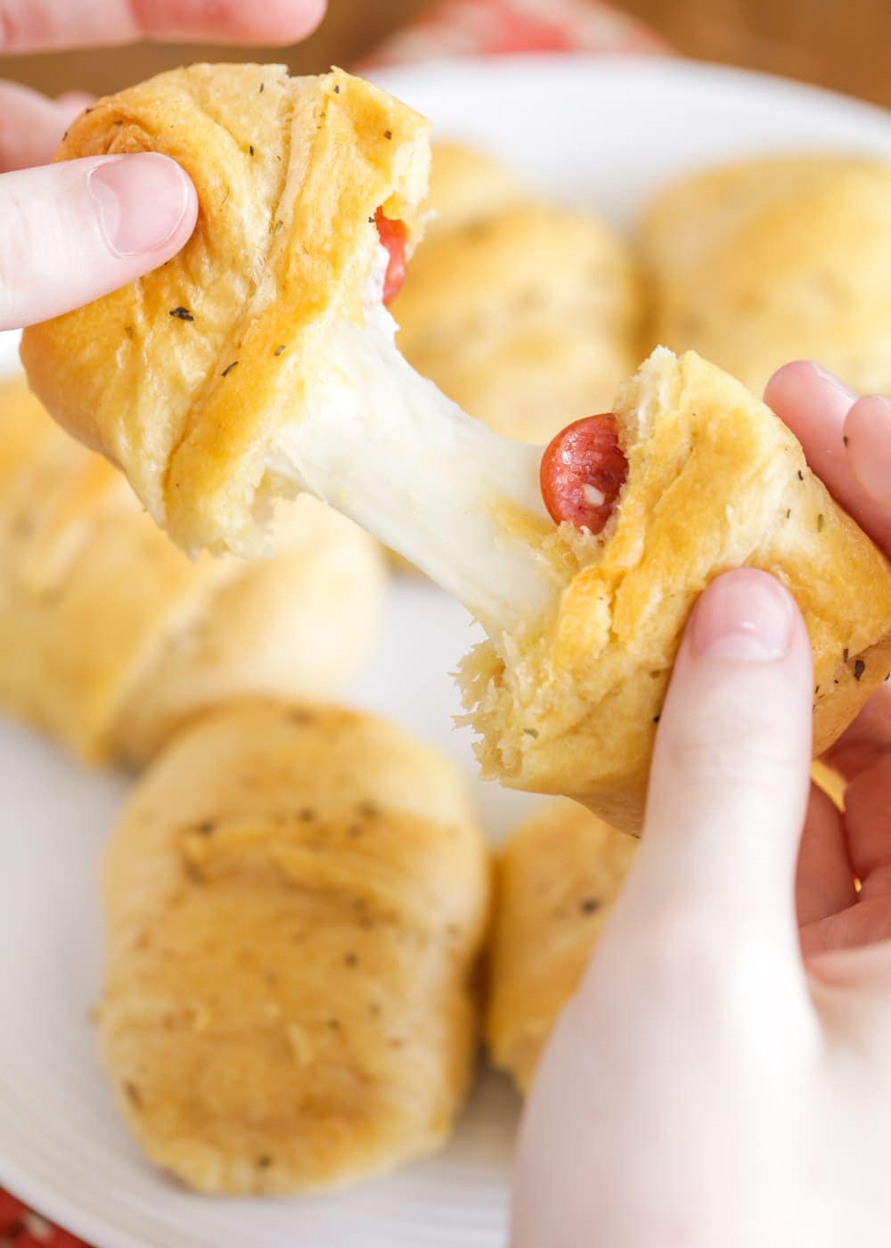 Breaking apart a crescent roll pizza roll up