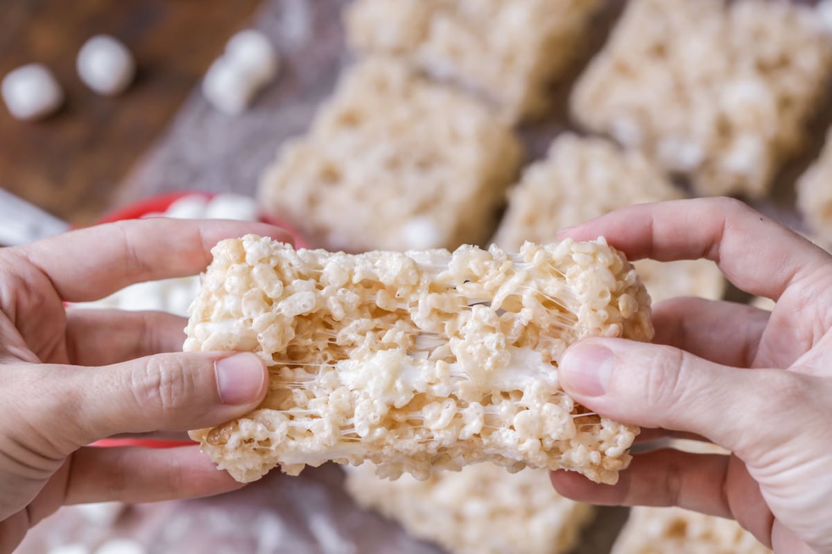 Pulling apart a gooey rice krispie treat.