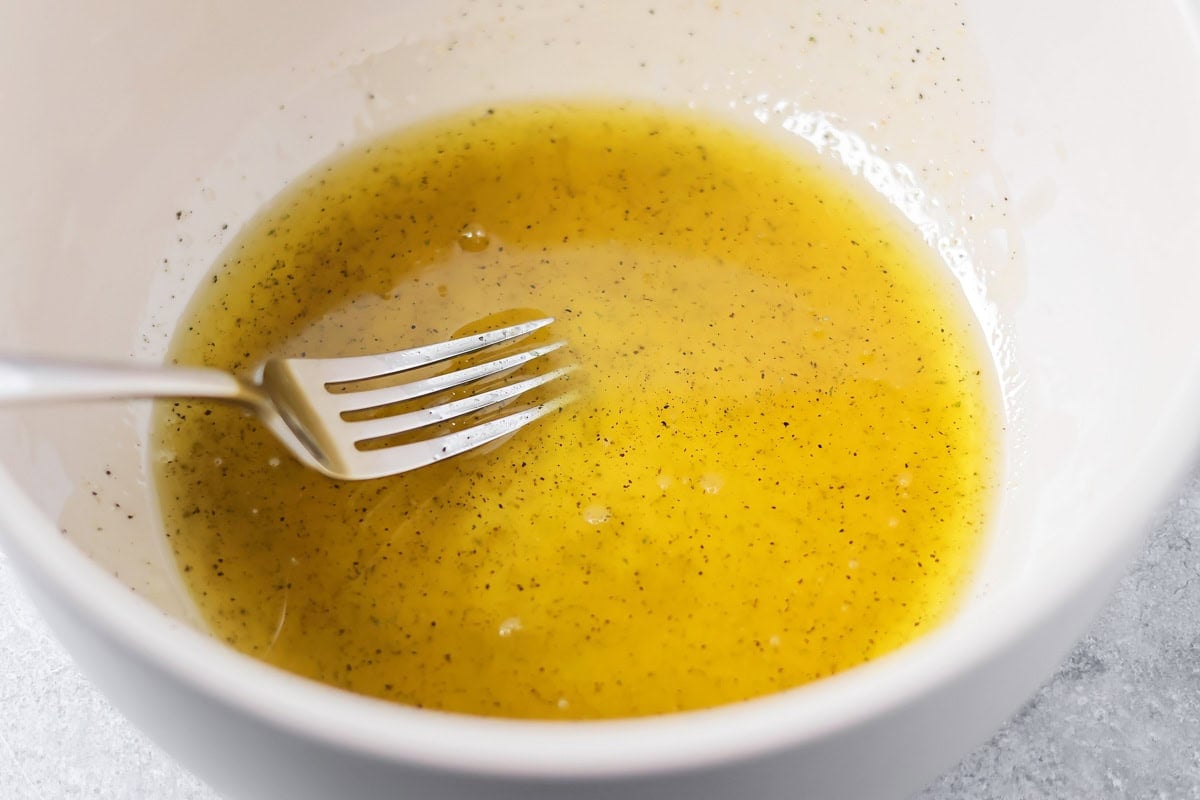 Lemon garlic olive oil in bowl for roasted broccoli recipe.