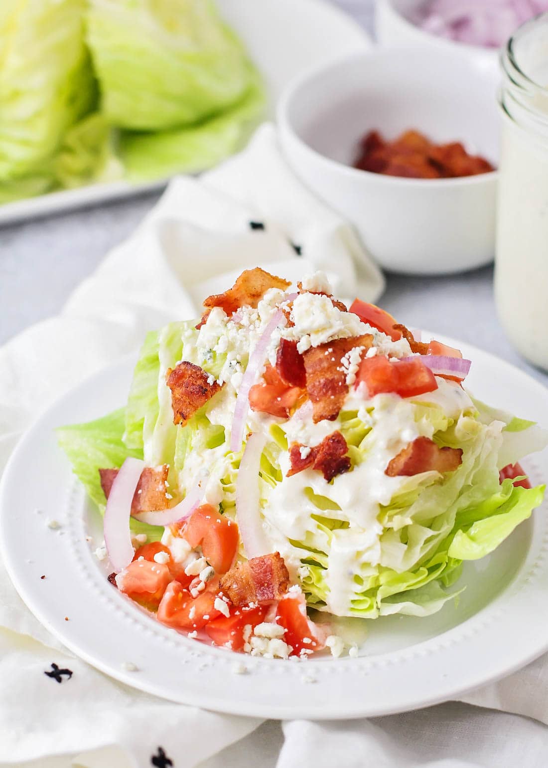 Wedge salad served on a white plate.