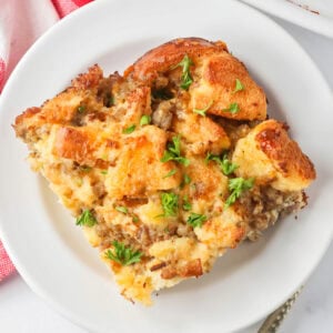 Christmas breakfast casserole slice served on a white plate.
