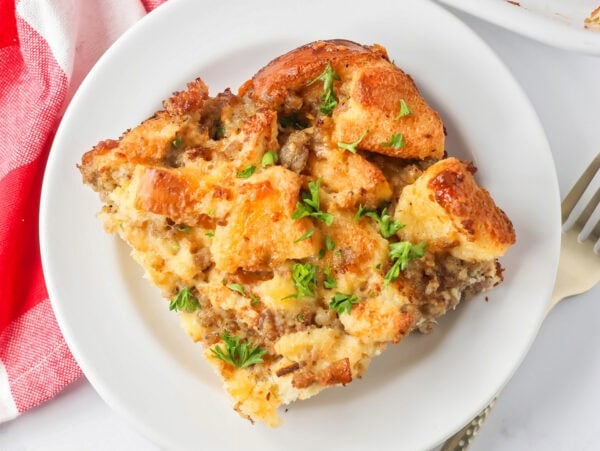 Christmas breakfast casserole slice served on a white plate.