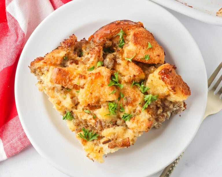 Christmas breakfast casserole slice served on a white plate.