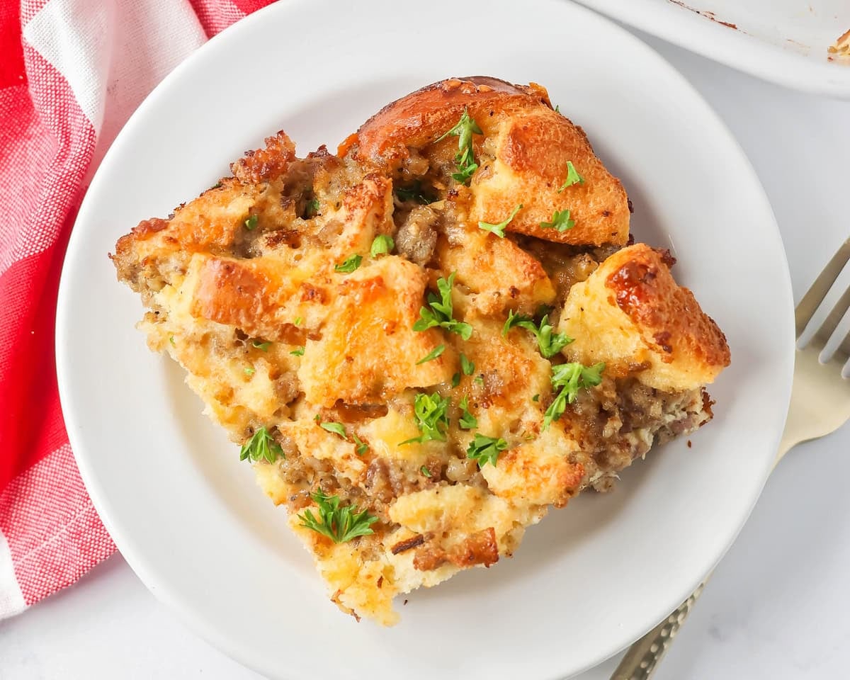 A slice of Christmas breakfast casserole on a white plate.