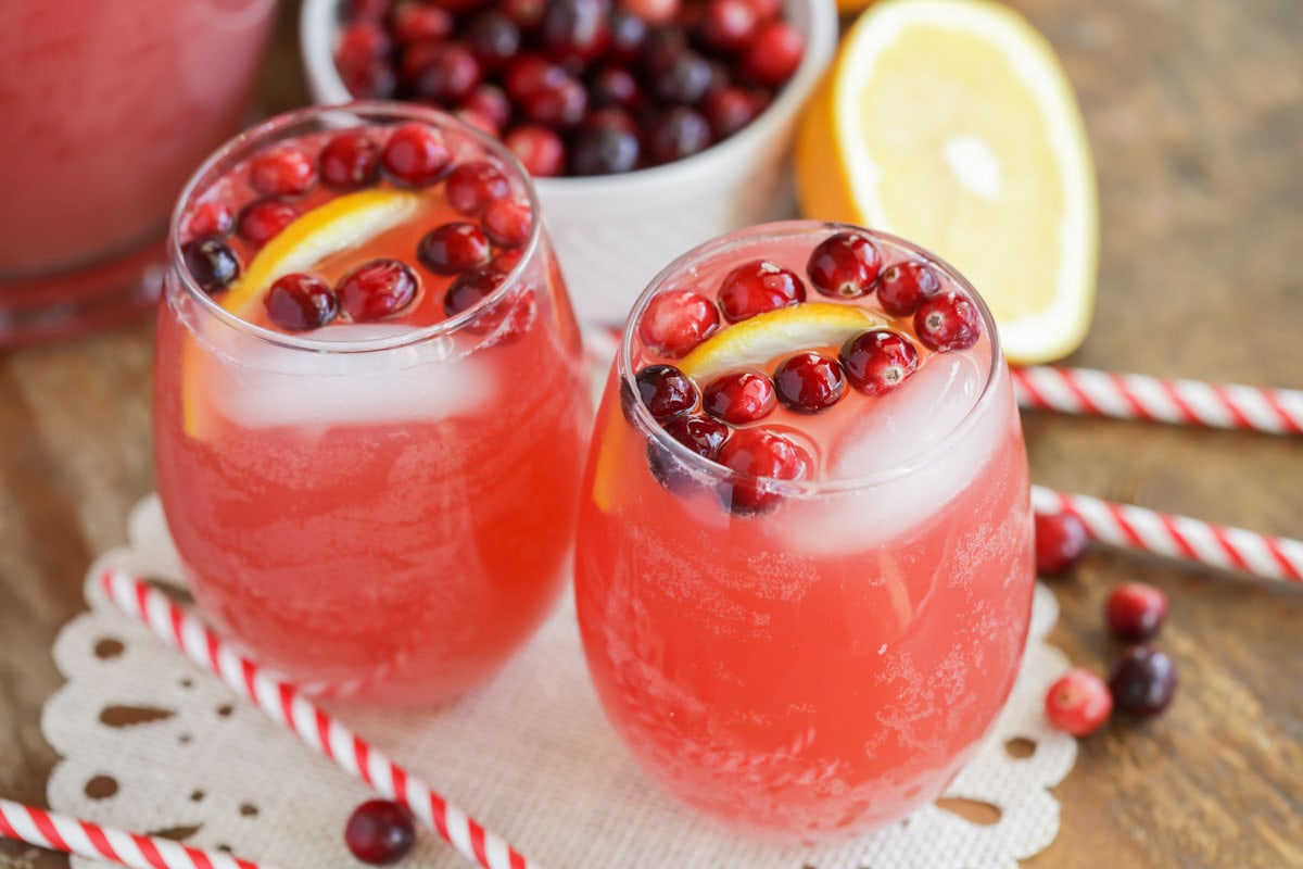 Holiday drink ideas - holiday punch garnished with fresh cranberries and orange wedges.