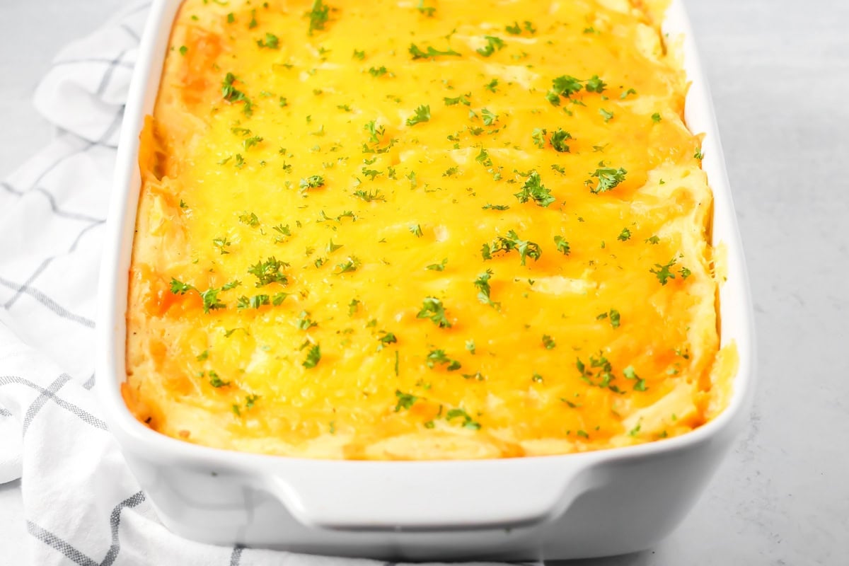 A cheesy baked thanksgiving leftover casserole with fresh herbs.