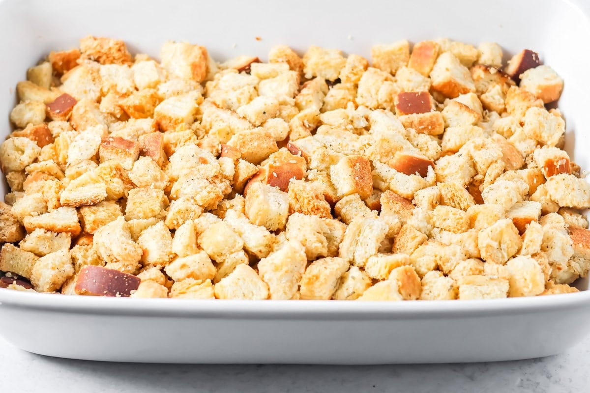 Stuffing spread in a baking dish for thanksgiving leftover casserole.