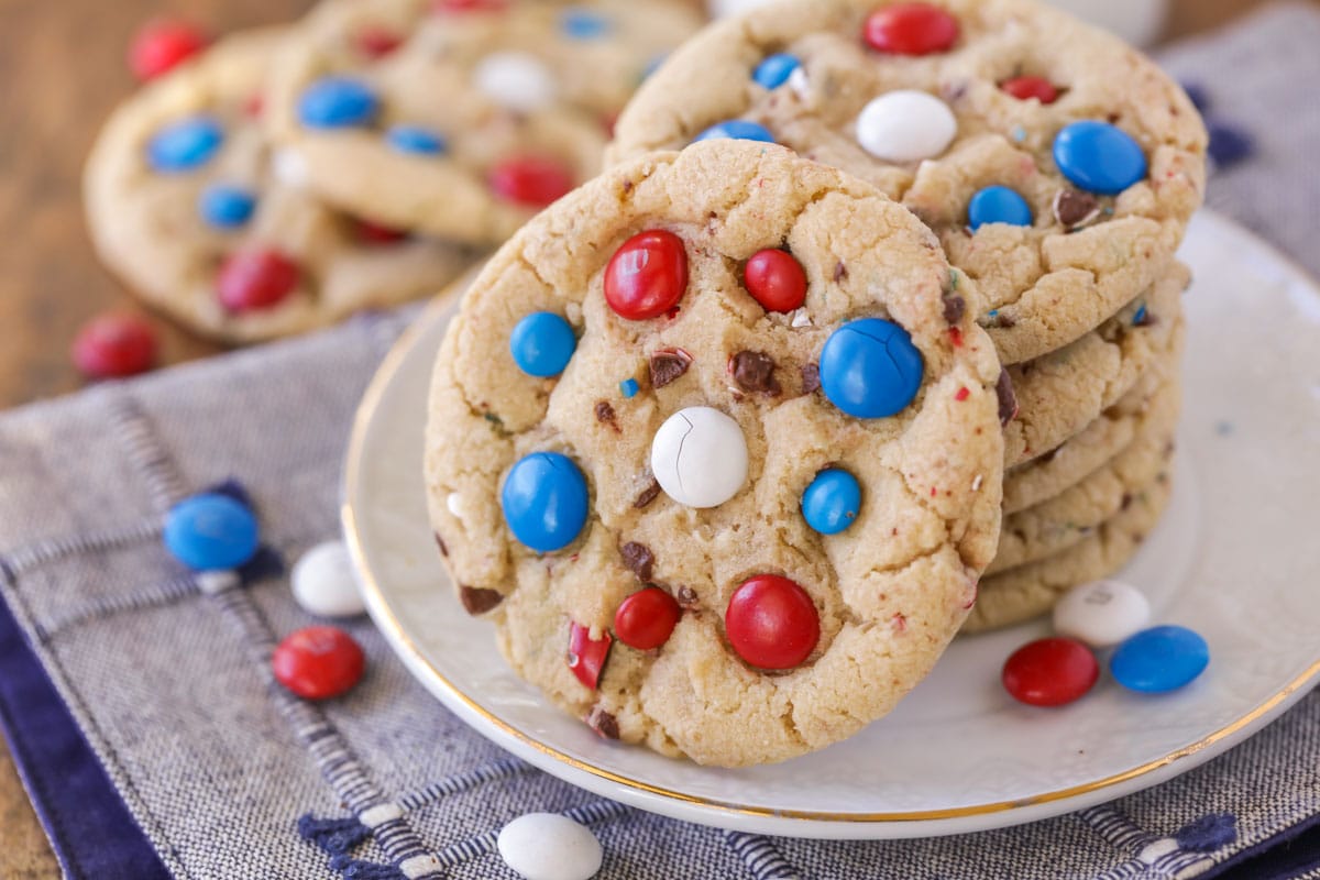 4th of July cookies stacked on a white plate.