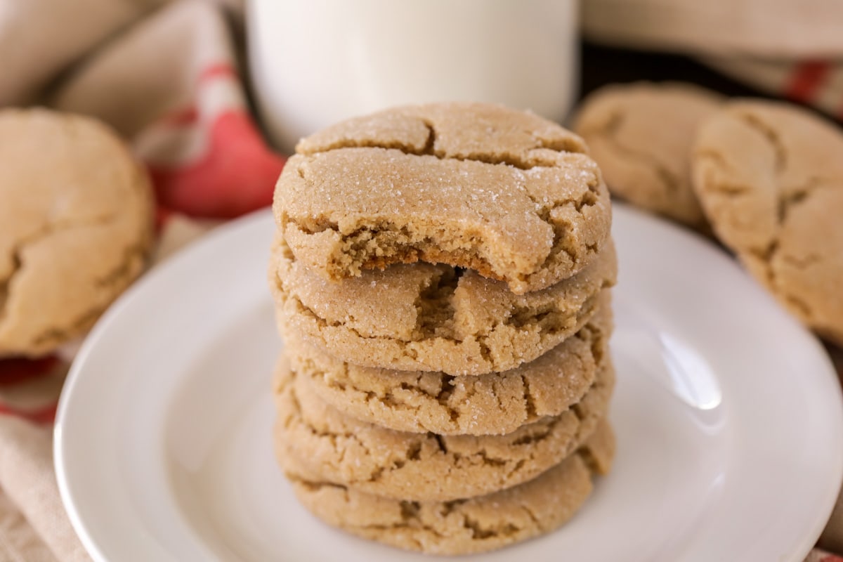 Brown sugar cookies stacked on a white plate