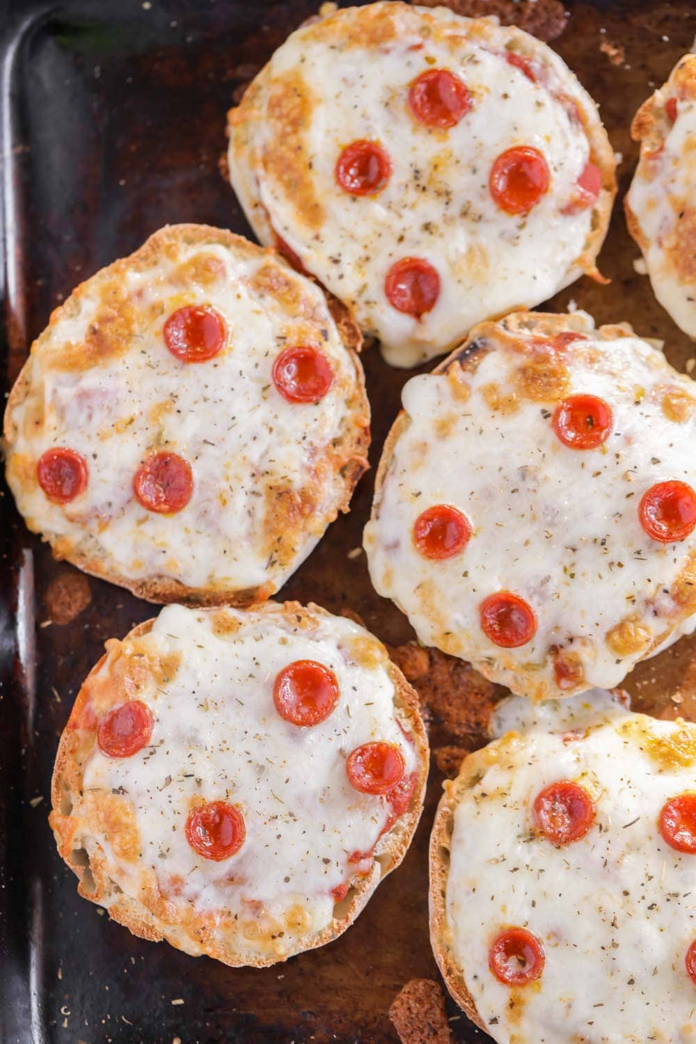 Pepperoni English Muffin Pizzas on a baking sheet