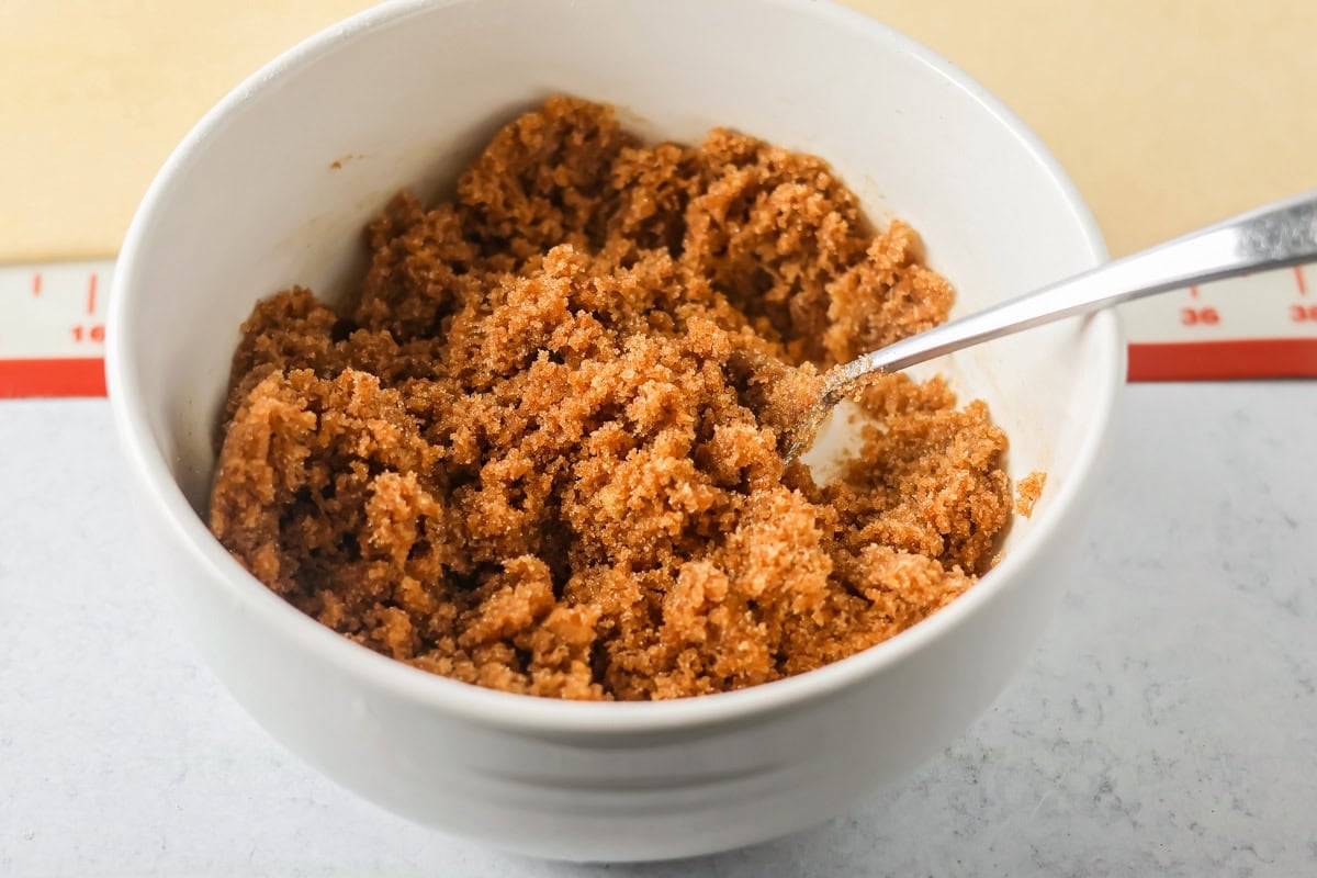 A bowl of cinnamon and sugar for filling mini cinnamon rolls.