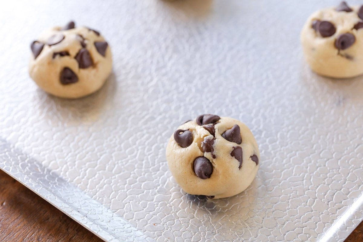 Nestle chocolate chip cookie balls on a sheet pan