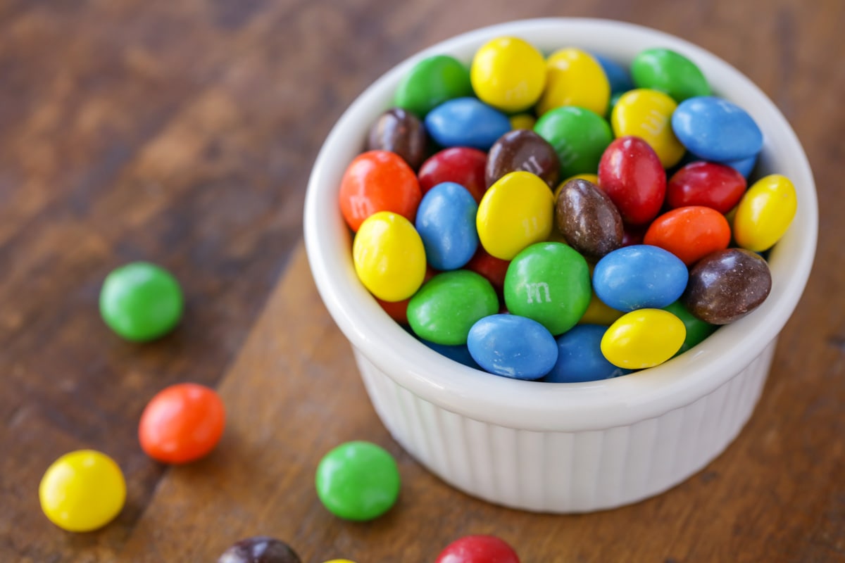 A white bowl filled with peanut butter m&ms.